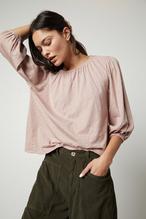 The model is wearing a Velvet by Graham & Spencer JULIE 3/4 SLEEVE TEE top and olive pants.