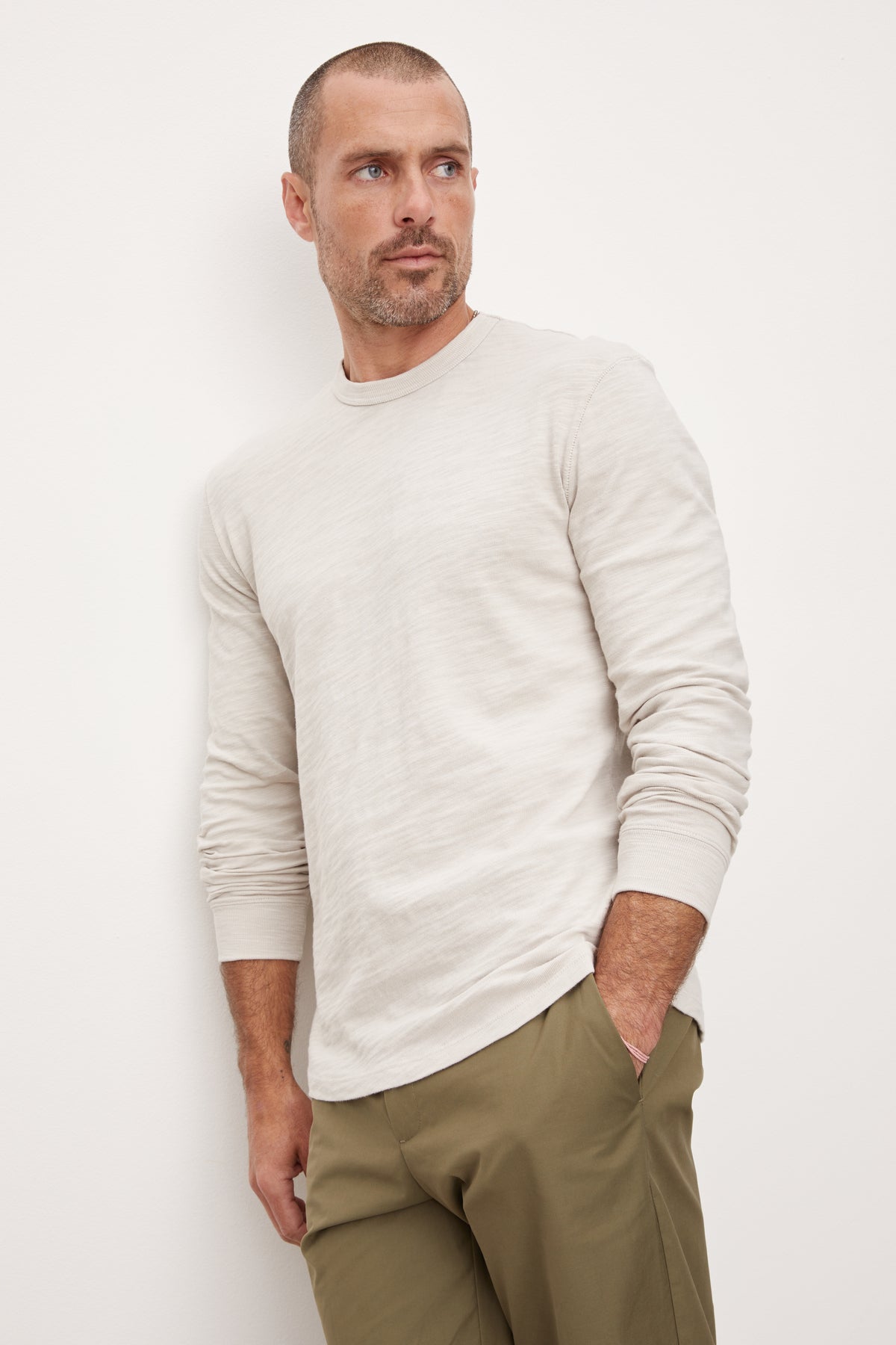 A man wearing a Velvet by Graham & Spencer PALMER CREW NECK TEE and khaki pants.-36008977465537