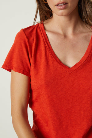 a woman wearing an orange Velvet by Graham & Spencer LILITH COTTON SLUB V-NECK TEE.