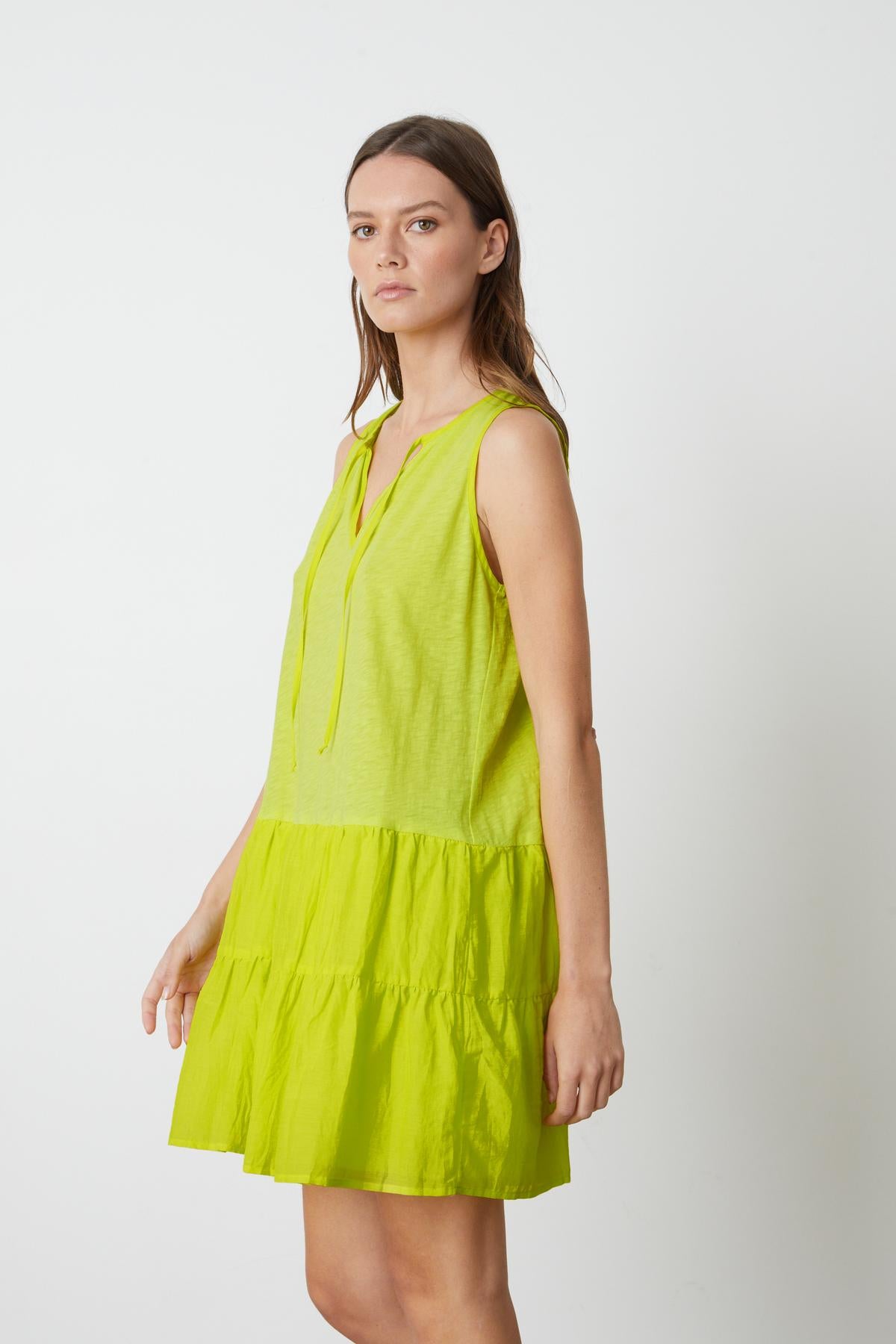 A model wearing the Velvet by Graham & Spencer PAIGE TIERED DRESS.
