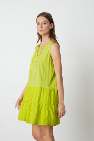 A model wearing the Velvet by Graham & Spencer PAIGE TIERED DRESS.