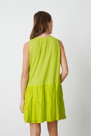 The back view of a woman in a Velvet by Graham & Spencer PAIGE TIERED DRESS.