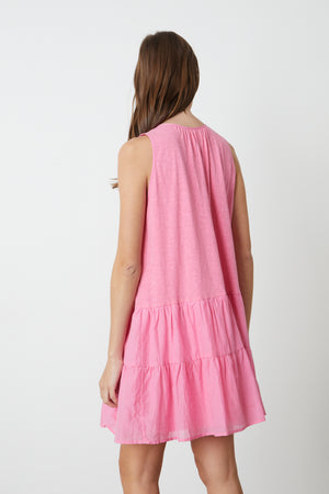 The view of a woman wearing a Velvet by Graham & Spencer PAIGE TIERED DRESS.