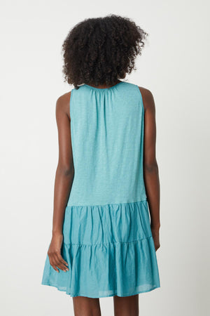 The back view of a woman wearing a Velvet by Graham & Spencer PAIGE TIERED DRESS.