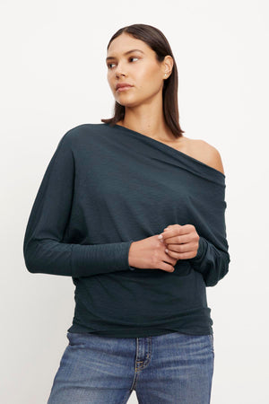 A woman wearing jeans and a Velvet by Graham & Spencer NOVALEE DOLMAN TEE.