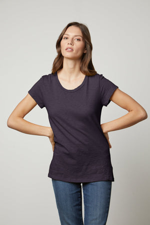 a woman wearing a dark blue ODELIA COTTON SLUB CREW NECK TEE by Velvet by Graham & Spencer and jeans.