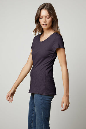 A woman wearing a Velvet by Graham & Spencer ODELIA COTTON SLUB CREW NECK TEE and jeans.