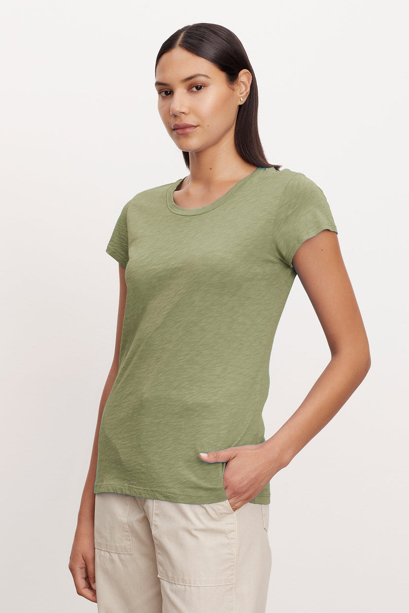 A woman wearing a Velvet by Graham & Spencer ODELIA COTTON SLUB CREW NECK TEE.