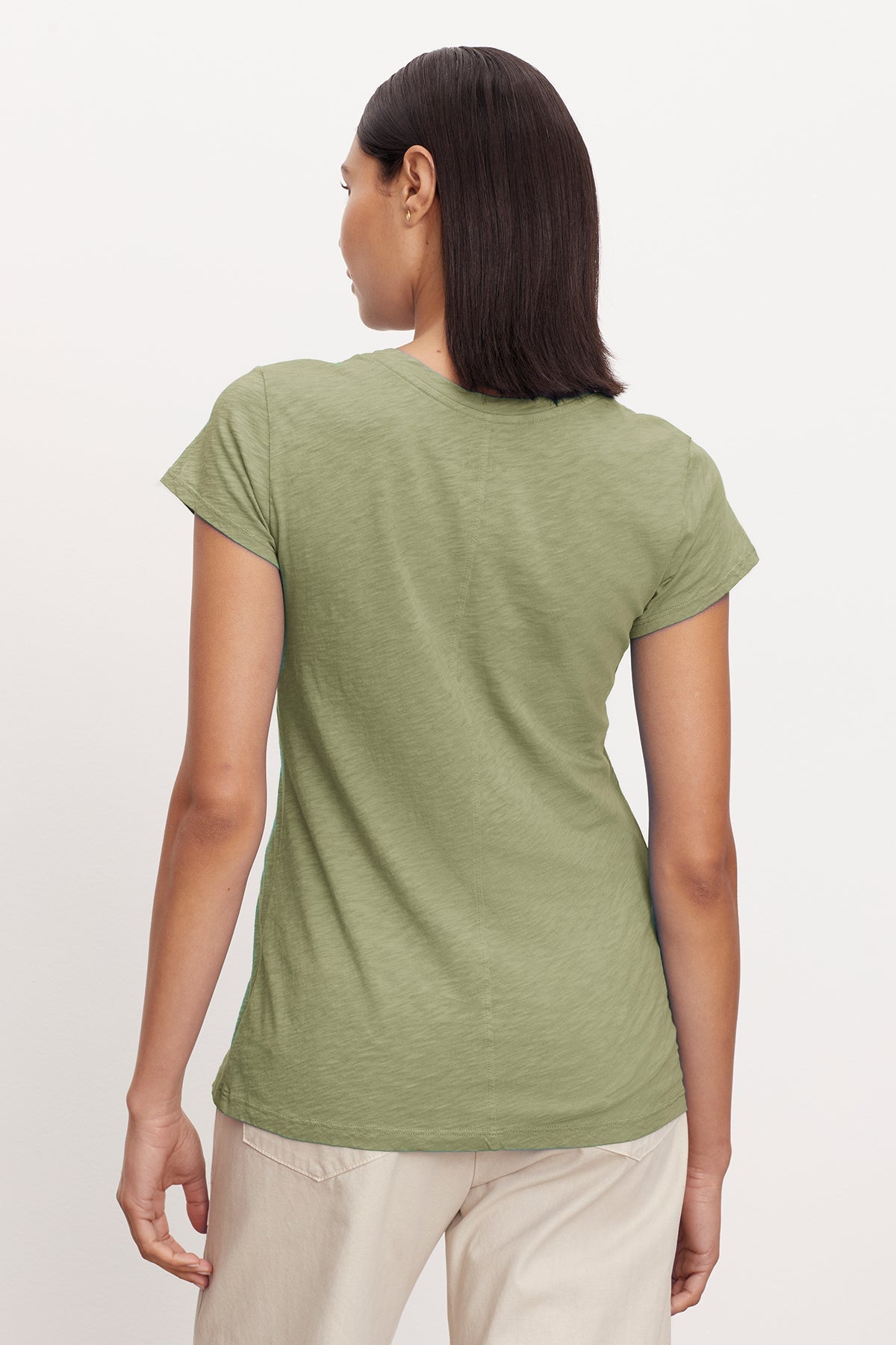 The back view of a woman wearing a Velvet by Graham & Spencer ODELIA COTTON SLUB CREW NECK TEE.-35567693988033