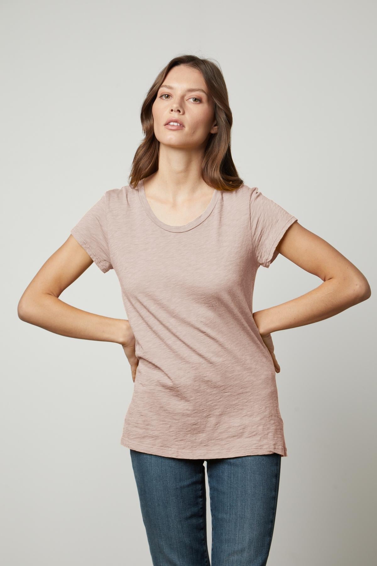 A woman wearing an ODELIA COTTON SLUB CREW NECK TEE by Velvet by Graham & Spencer and jeans.-35567694184641