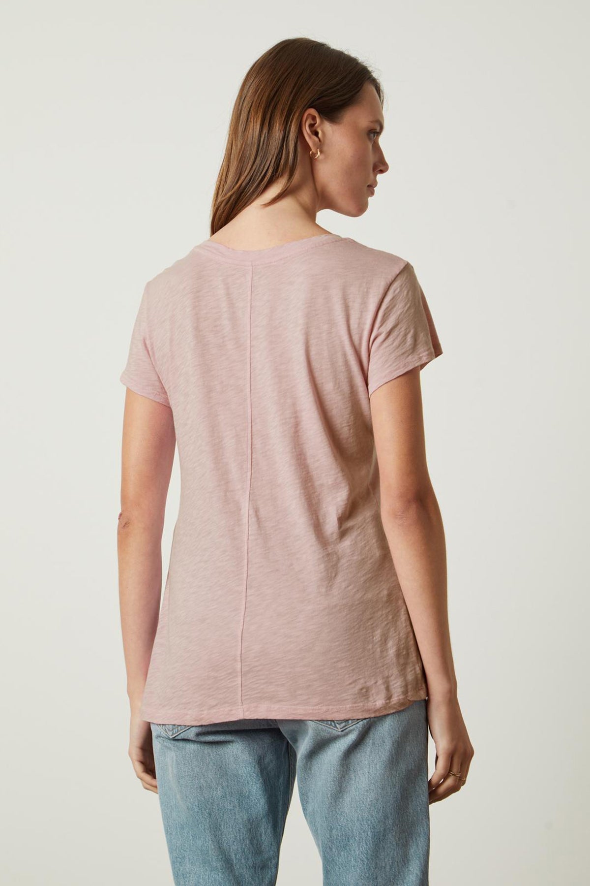 The back view of a woman wearing a Velvet by Graham & Spencer ODELIA COTTON SLUB CREW NECK TEE.-35567694151873