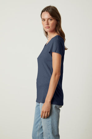 A woman wearing jeans and a blue ODELIA COTTON SLUB CREW NECK TEE by Velvet by Graham & Spencer.