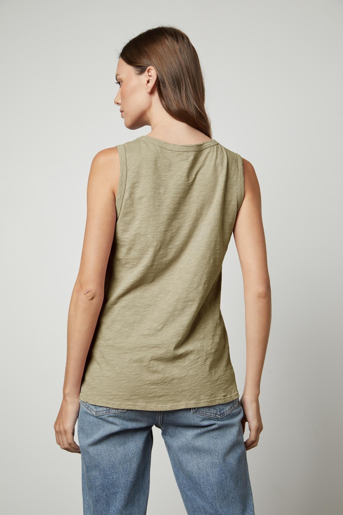 the back view of a woman wearing Velvet by Graham & Spencer's TAURUS COTTON SLUB TANK in sage green.