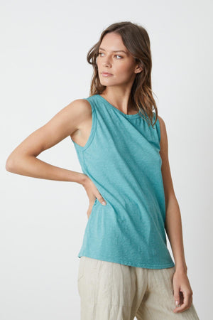 A woman wearing the Velvet by Graham & Spencer TAURUS COTTON SLUB TANK and Dru pants.