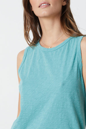 Close up detail of woman wearing a Velvet by Graham & Spencer TAURUS COTTON SLUB TANK in turquoise.