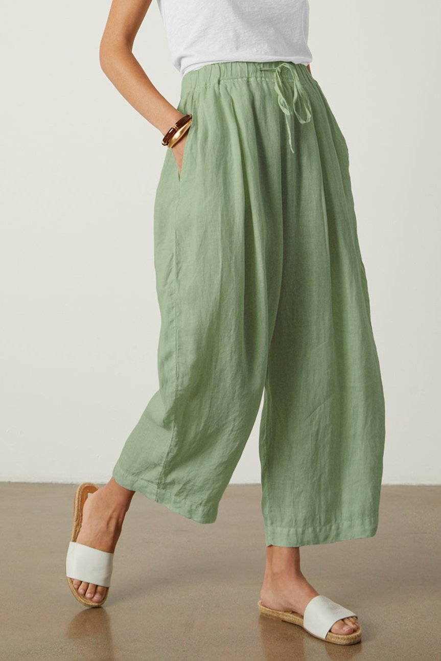 A woman wearing the Velvet by Graham & Spencer Hannah Linen Wide Leg Pant with a cropped leg.-35982213415105