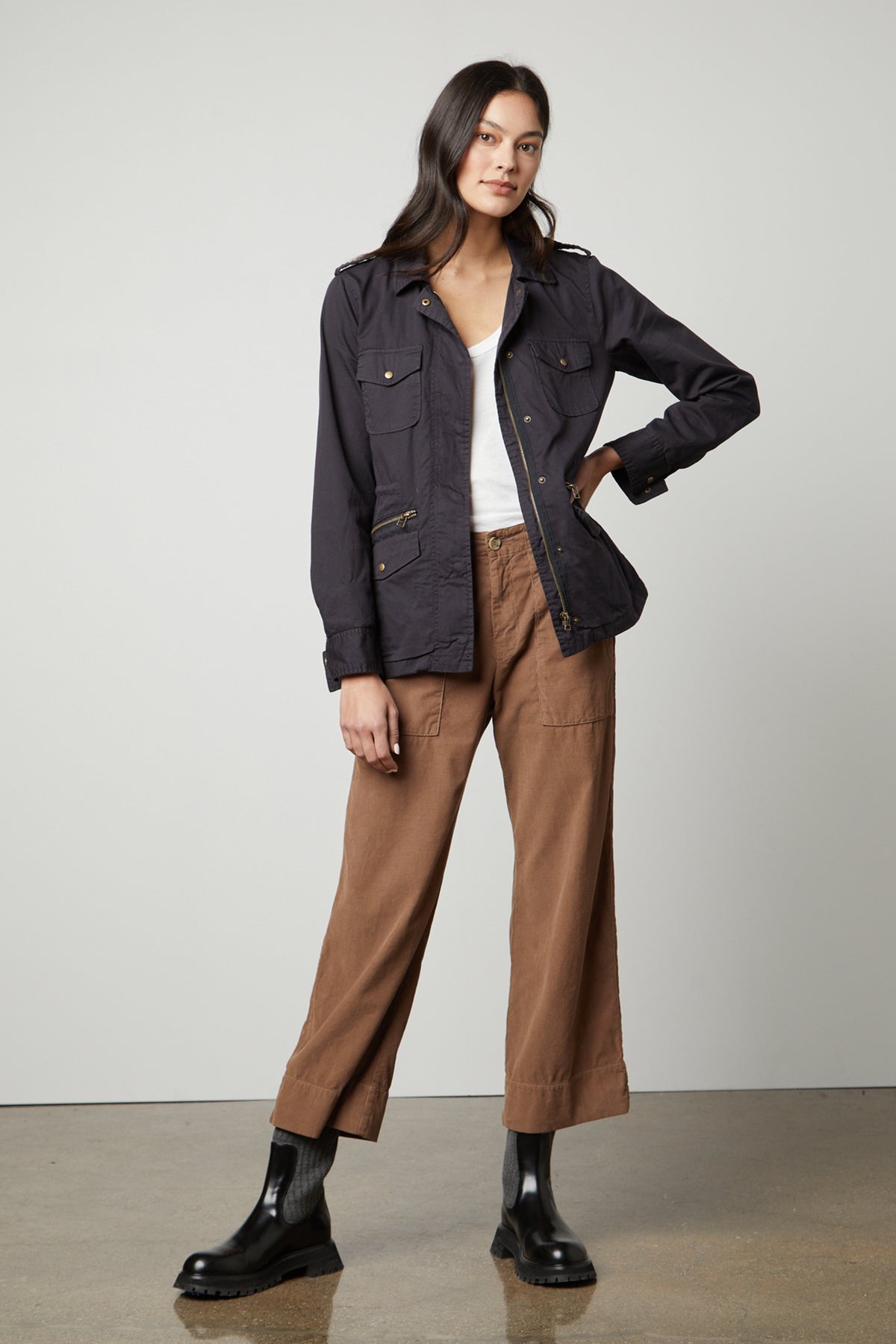 The model is wearing a RUBY LIGHT-WEIGHT ARMY JACKET from Velvet by Graham & Spencer, showcasing its versatility in the closet.-35783096697025