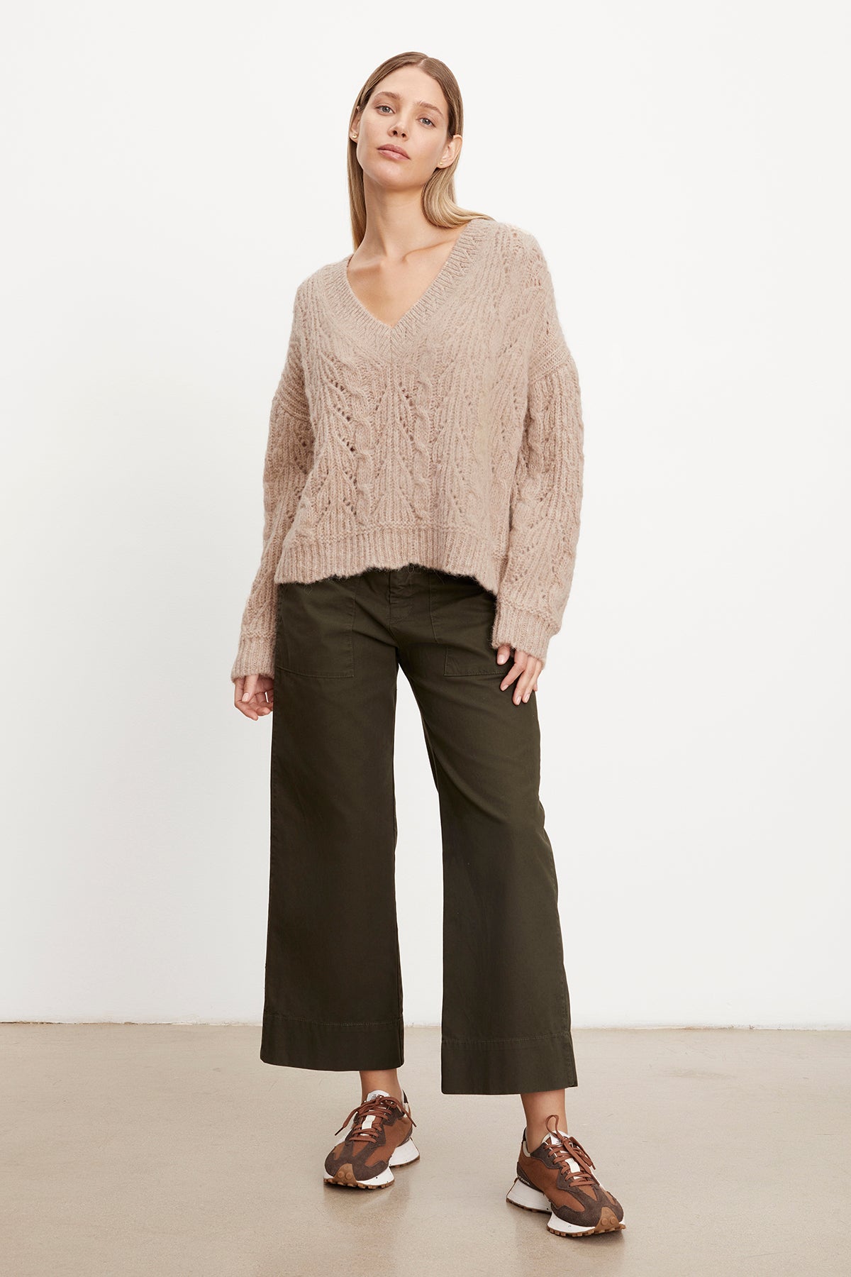 The model is wearing a SADE ALPACA BLEND V-NECK SWEATER by Velvet by Graham & Spencer.