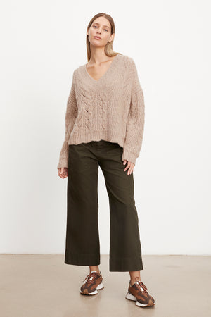 The model is wearing a SADE ALPACA BLEND V-NECK SWEATER by Velvet by Graham & Spencer.