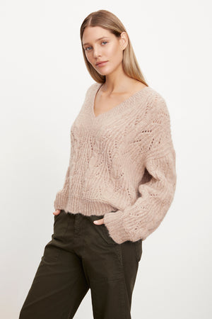 The model is wearing a Velvet by Graham & Spencer SADE ALPACA BLEND V-NECK SWEATER.