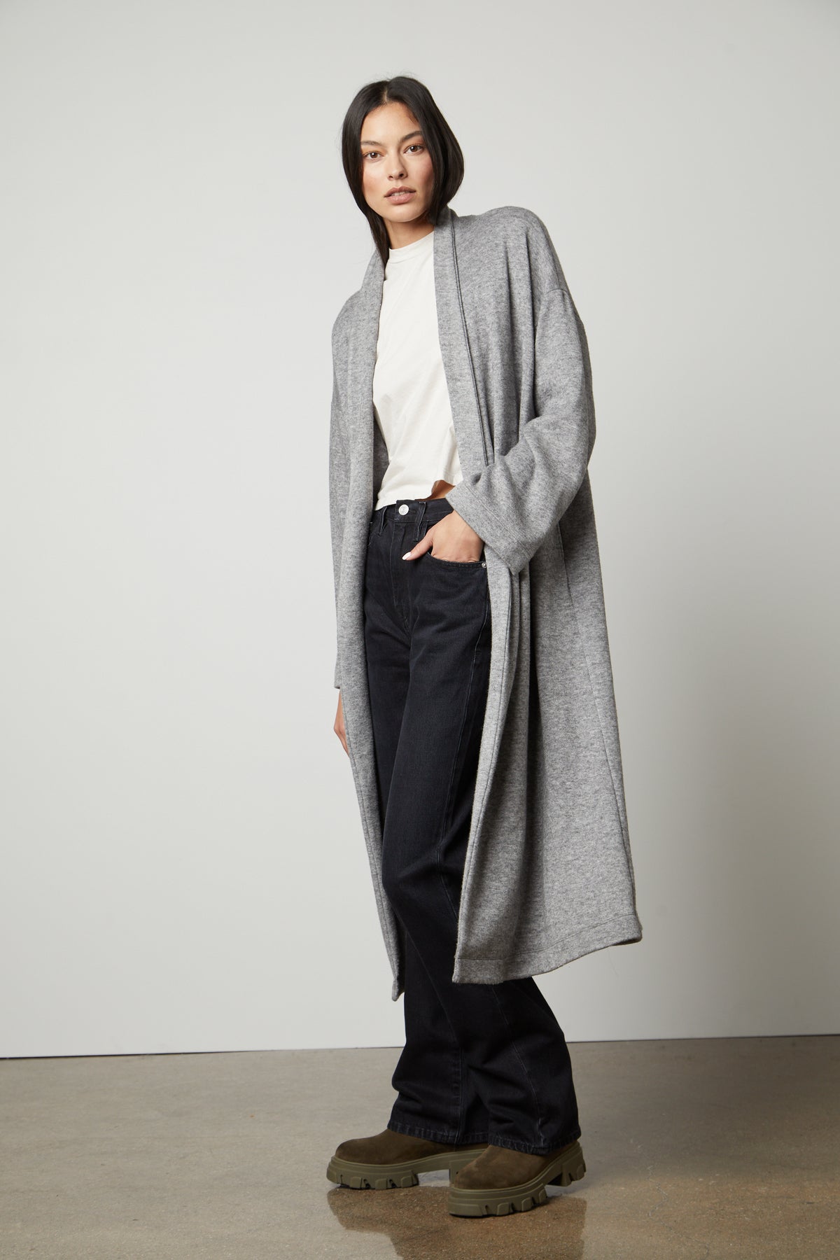 The model is wearing a Velvet by Graham & Spencer PATRICIA DOUBLE KNIT DUSTER CARDIGAN and jeans.