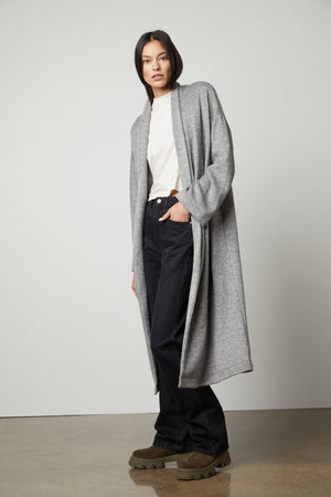 The model is wearing a Velvet by Graham & Spencer PATRICIA DOUBLE KNIT DUSTER CARDIGAN and jeans.