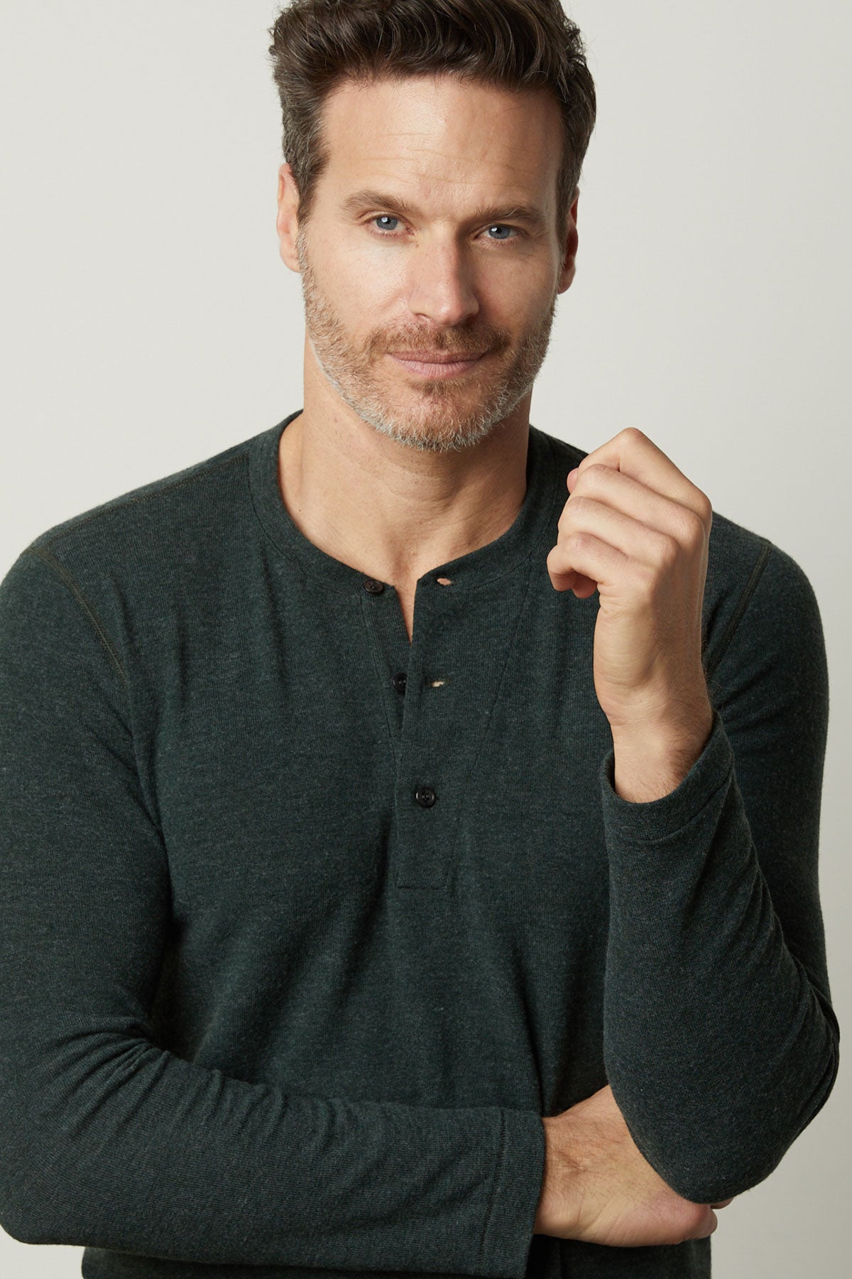 A man in a cozy Velvet by Graham & Spencer green Ryland Henley shirt posing for a photo.-35605854126273