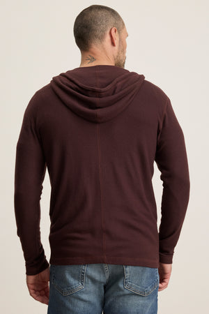 A man is shown from the back wearing the LOUDON HOODIE by Velvet by Graham & Spencer in maroon triblend jersey with blue jeans; a small tattoo is visible on his neck.