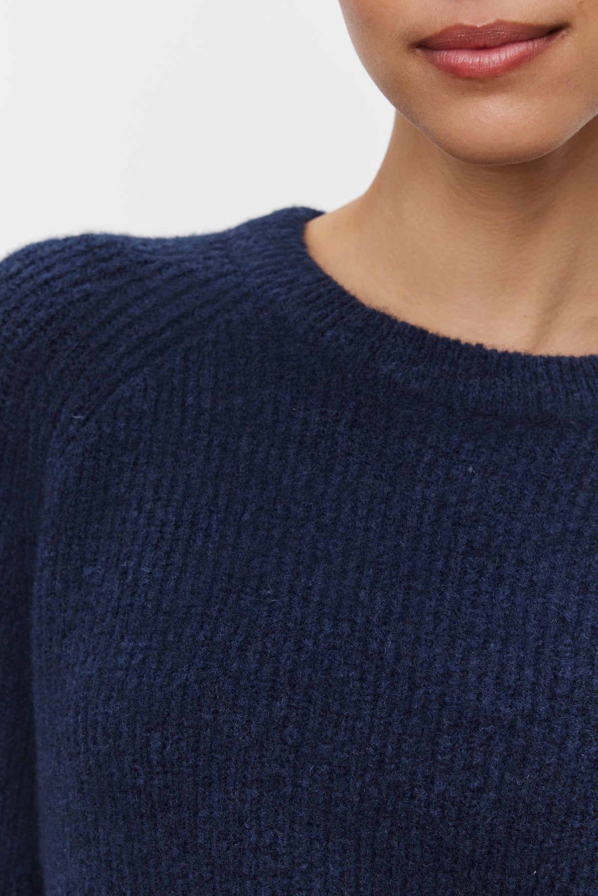 A person wearing the GIGI SWEATER by Velvet by Graham & Spencer, shown from the shoulders to the chin.