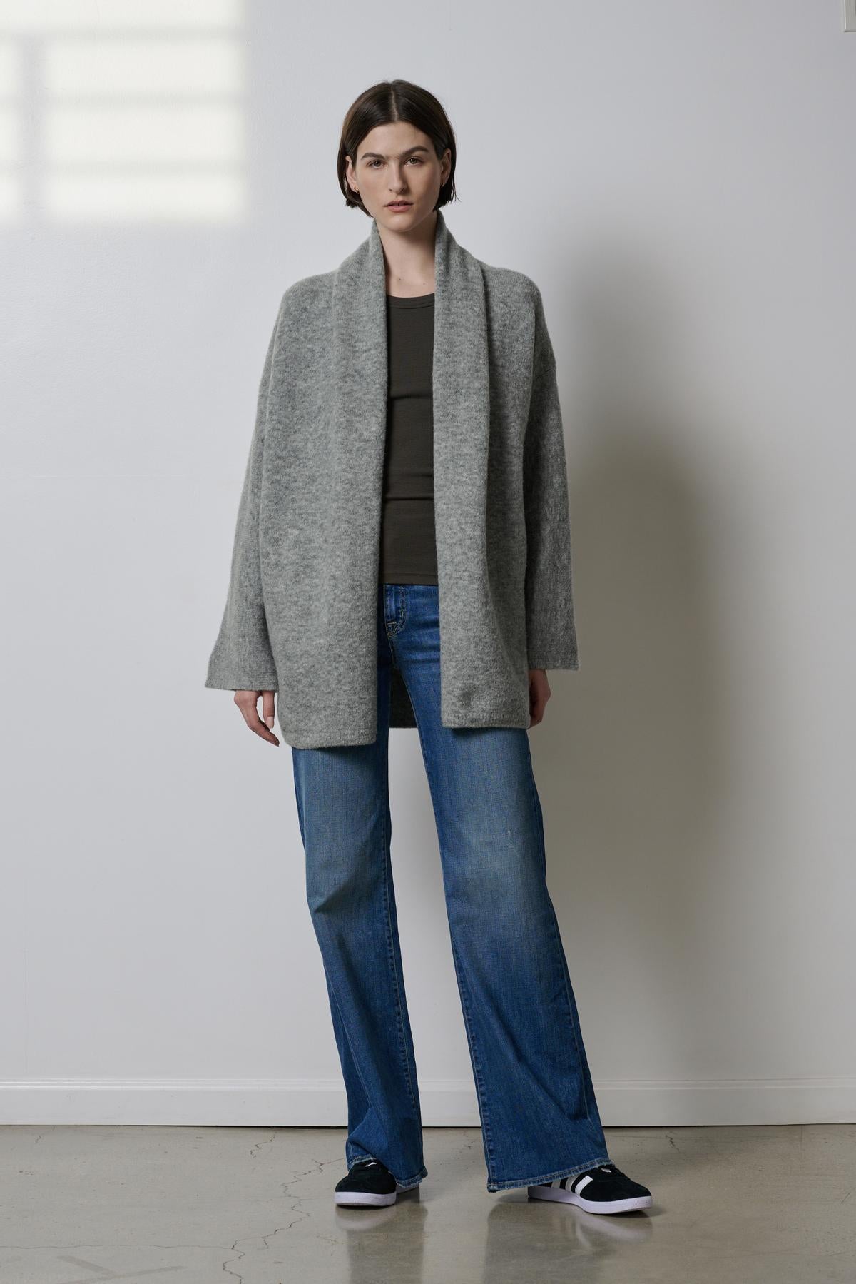 The model is wearing an oversized Velvet by Jenny Graham Sunset Jacket and jeans.-35190260302017
