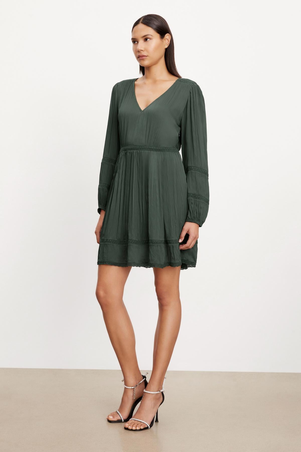 The model is wearing a Velvet by Graham & Spencer BETHEL LACE DRESS with lace inset detailing.-35630357283009
