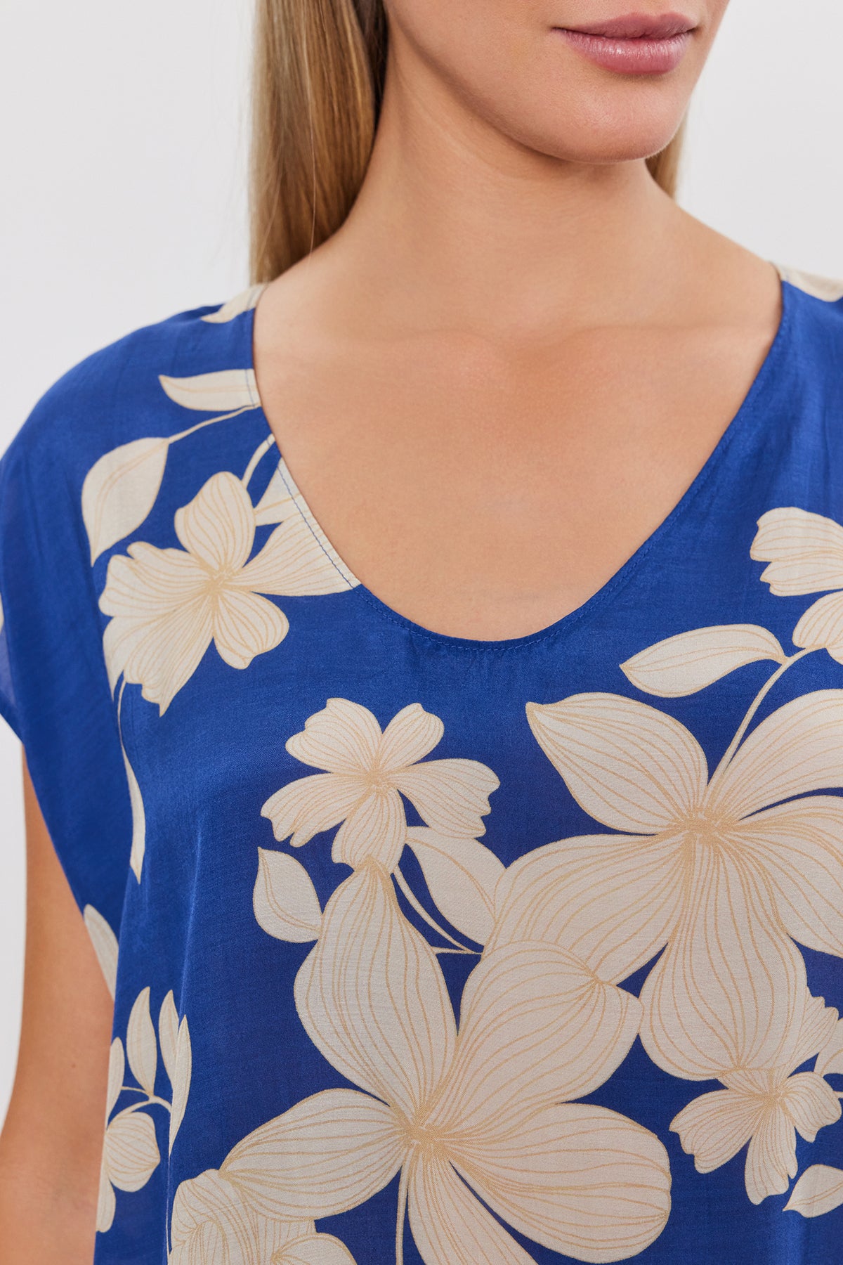 A woman wearing a Velvet by Graham & Spencer SHAYLEN PRINTED SCOOP NECK TOP with cap sleeves.-35655290355905