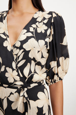 A woman wearing a Velvet by Graham & Spencer KAI PRINTED WRAP DRESS.