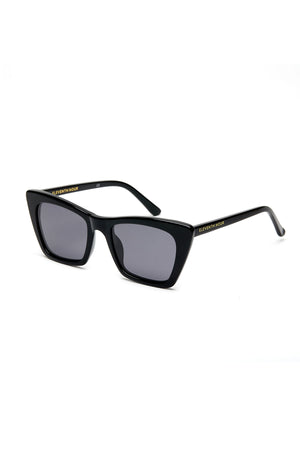 Black rectangular ESSENTIAL CLASSIC SUNGLASSES BY ELEVENTH HOUR with dark lenses and thin arms. The brand name, Eleventh Hour, is written on the arms in gold.