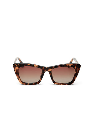 A pair of ESSENTIAL CLASSIC SUNGLASSES BY ELEVENTH HOUR with brown gradient lenses is centered against a white background.