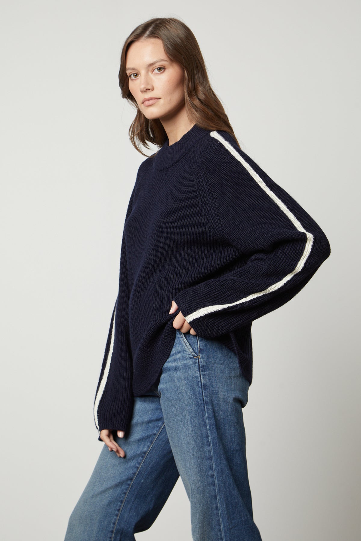 The model is wearing jeans and a Velvet by Graham & Spencer TEAGAN MOCK NECK SWEATER.-26897832018113
