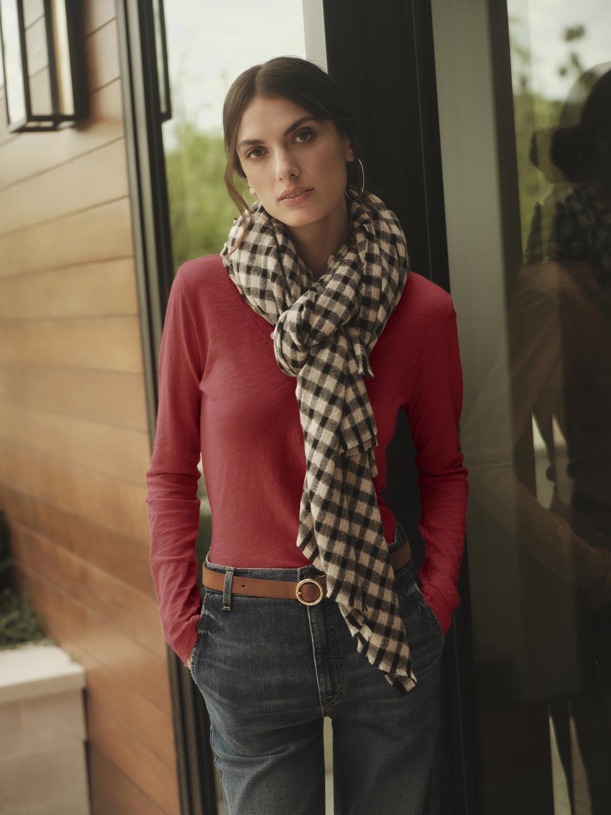 A woman wearing Velvet by Graham & Spencer whisper-soft cotton jeans and a plaid scarf.-36594536743105