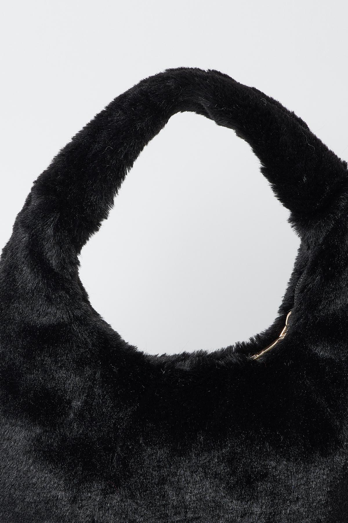 A luxurious FAUX FUR BAG by Velvet by Graham & Spencer on a stylish white surface.-35211044520129
