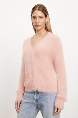 The model is wearing a Velvet by Graham & Spencer KELSEY FEATHER YARN CARDIGAN with ribbed trims.