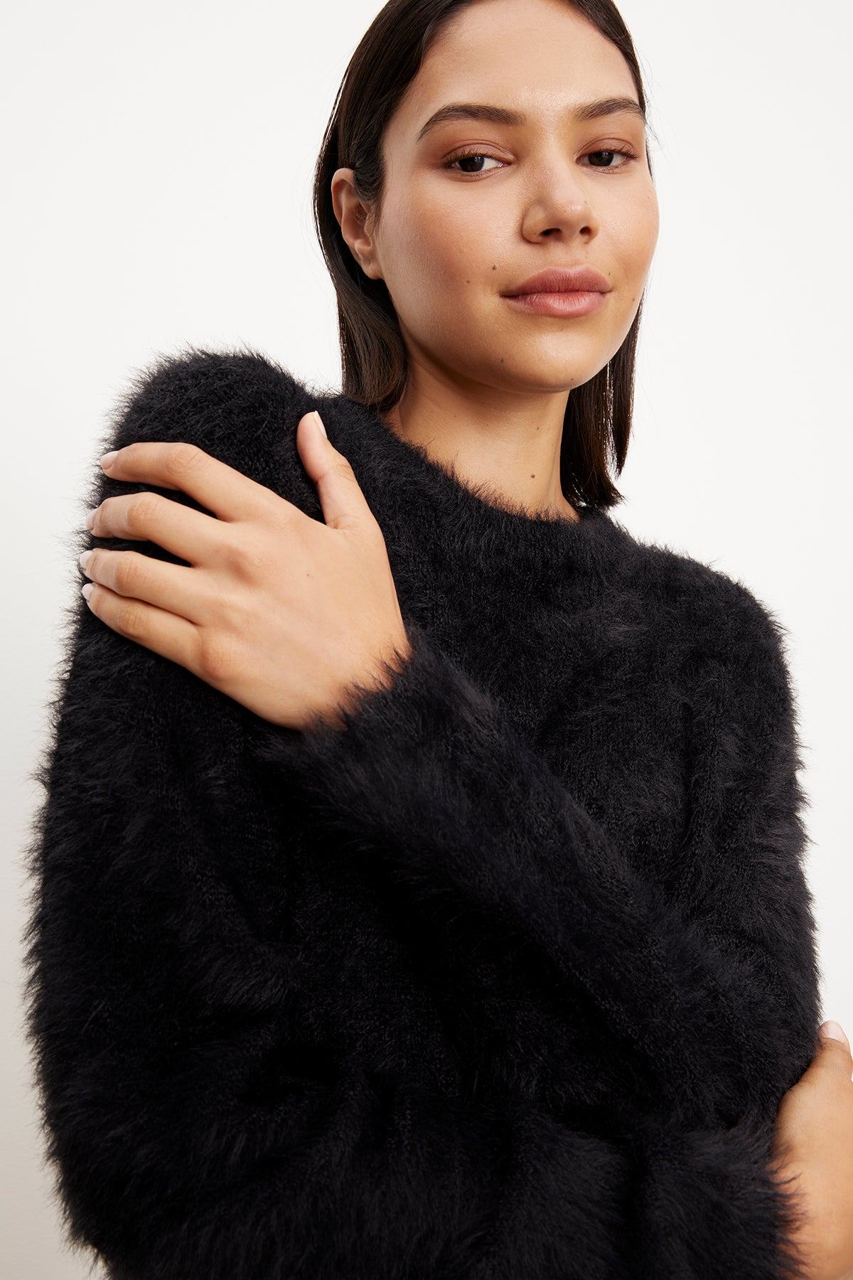 A model wearing a RAY FEATHER YARN CREW NECK SWEATER from Velvet by Graham & Spencer, with a luxe edge.