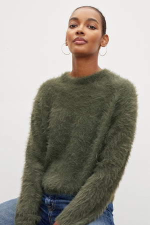 The model is wearing a Velvet by Graham & Spencer RAY FEATHER YARN CREW NECK SWEATER.