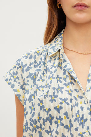 The model is wearing a Velvet by Graham & Spencer PAULETTE FLORAL BUTTON FRONT TOP with subtle stripe details.