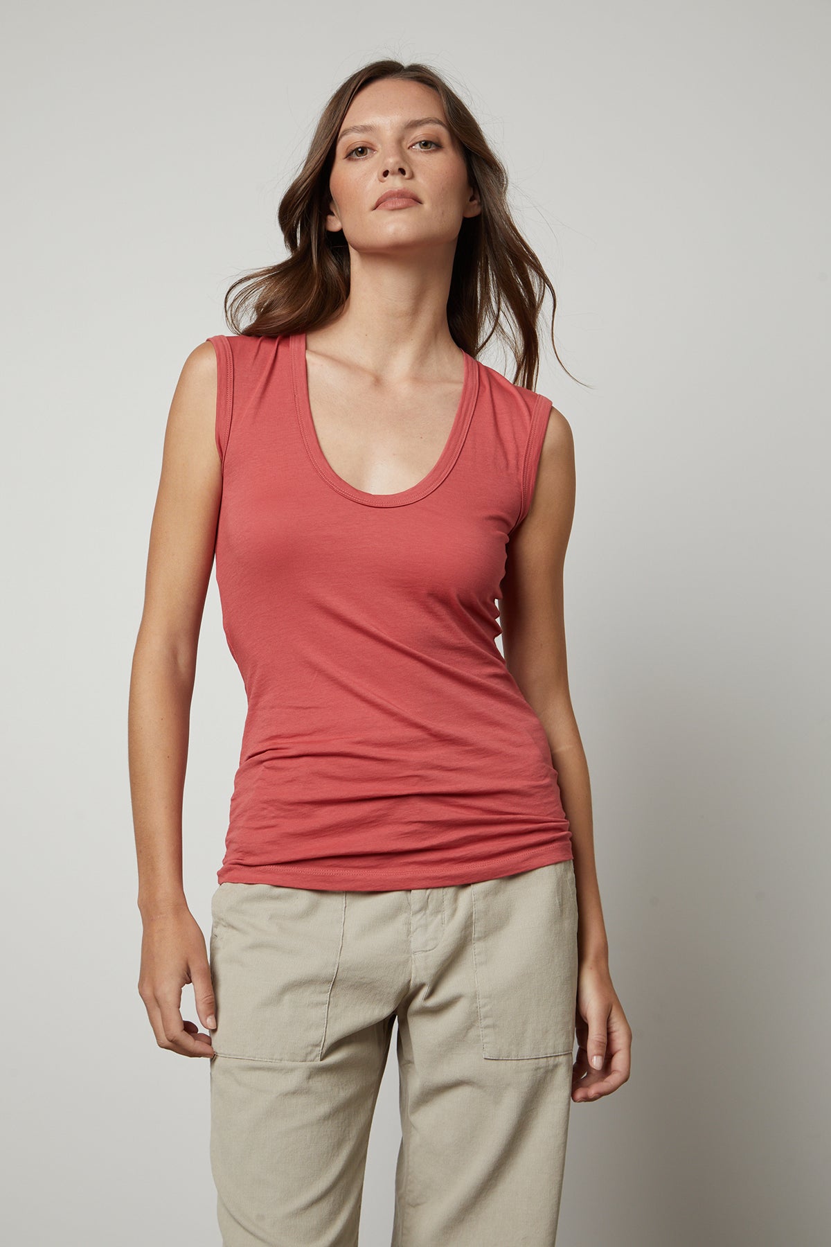 A woman wearing a Velvet by Graham & Spencer ESTINA GAUZY WHISPER FITTED TANK TOP and khaki pants.