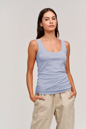 a woman wearing a Velvet by Graham & Spencer MOSSY GAUZY WHISPER FITTED TANK and khaki pants.