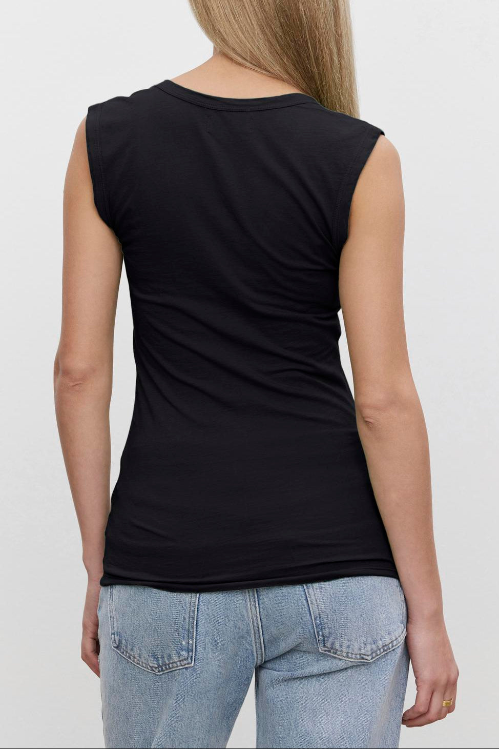 A person with long, straight hair is shown from the back, wearing a black ESTINA TANK TOP by Velvet by Graham & Spencer and light blue jeans against a plain white background.