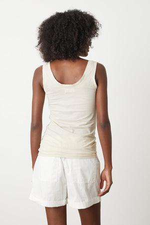 the back view of a woman wearing white shorts and a Velvet by Graham & Spencer MOSSY GAUZY WHISPER FITTED TANK.