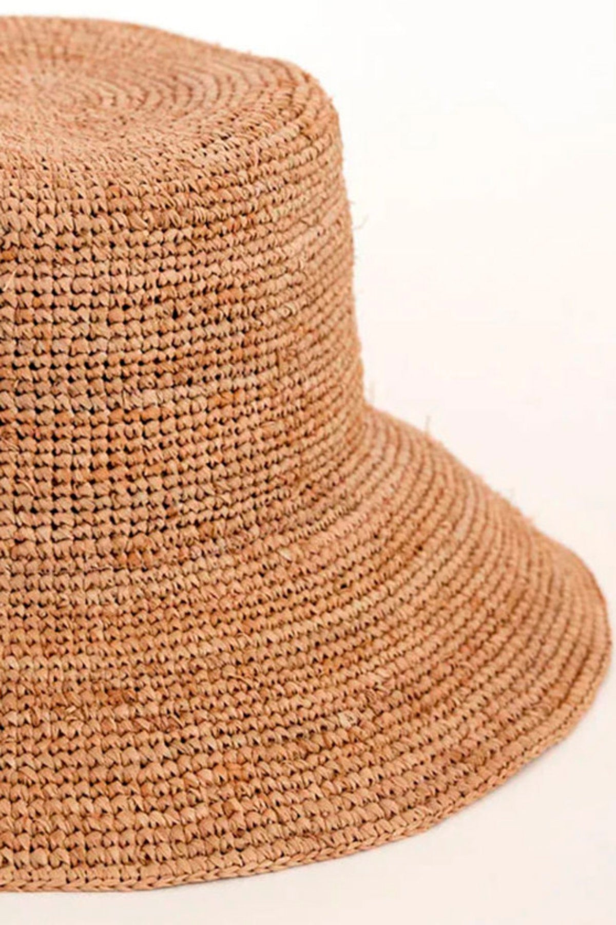The CHIC CROCHET BUCKET HAT by Velvet by Graham & Spencer features a raffia design with a slightly flared brim, set elegantly against a plain, light background for stylish sun protection.