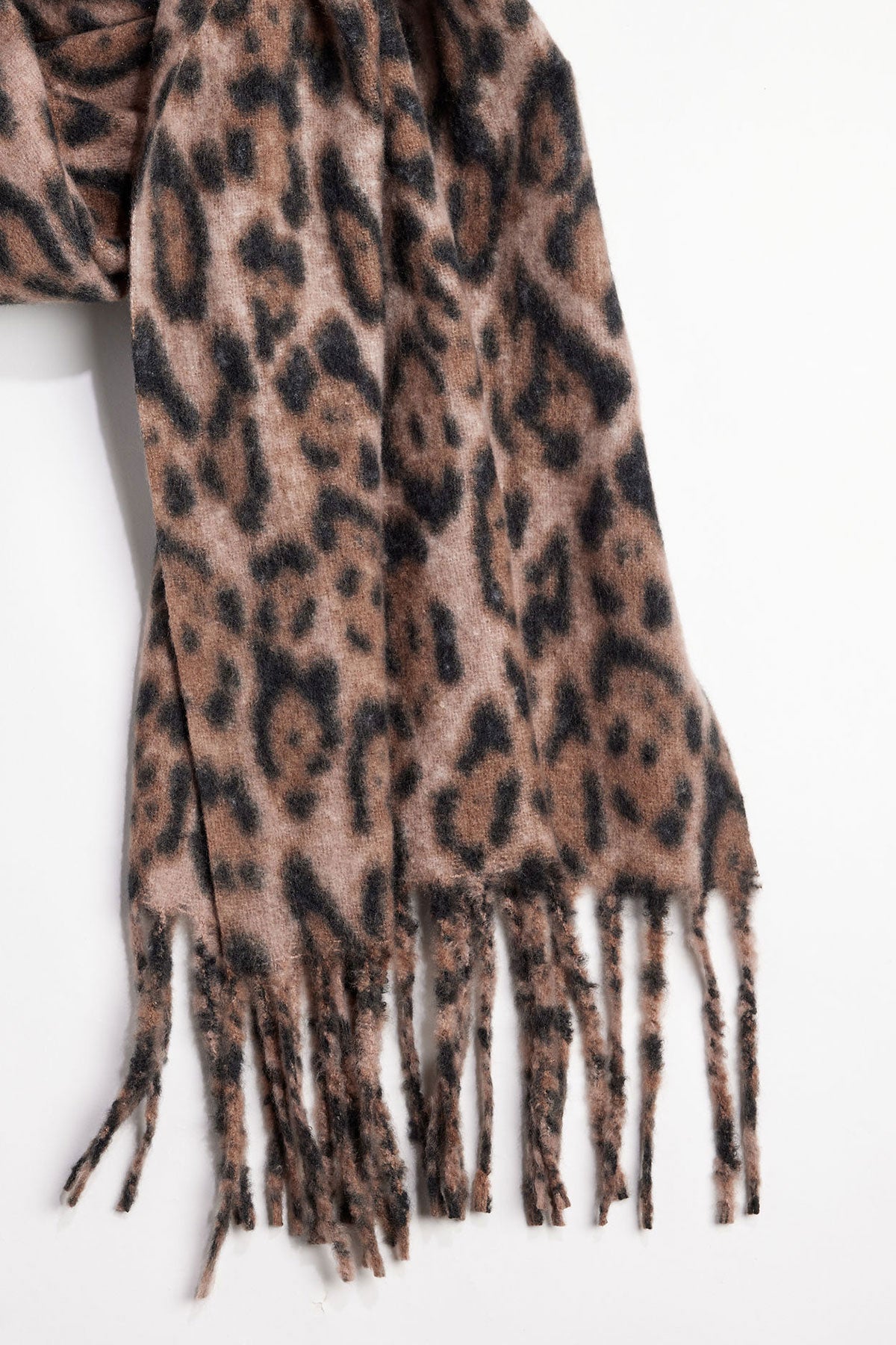 The LEOPARD SCARF by Velvet by Graham & Spencer, featuring a brown and black leopard print and fringed ends, is shown against a plain white background.-39850444095681