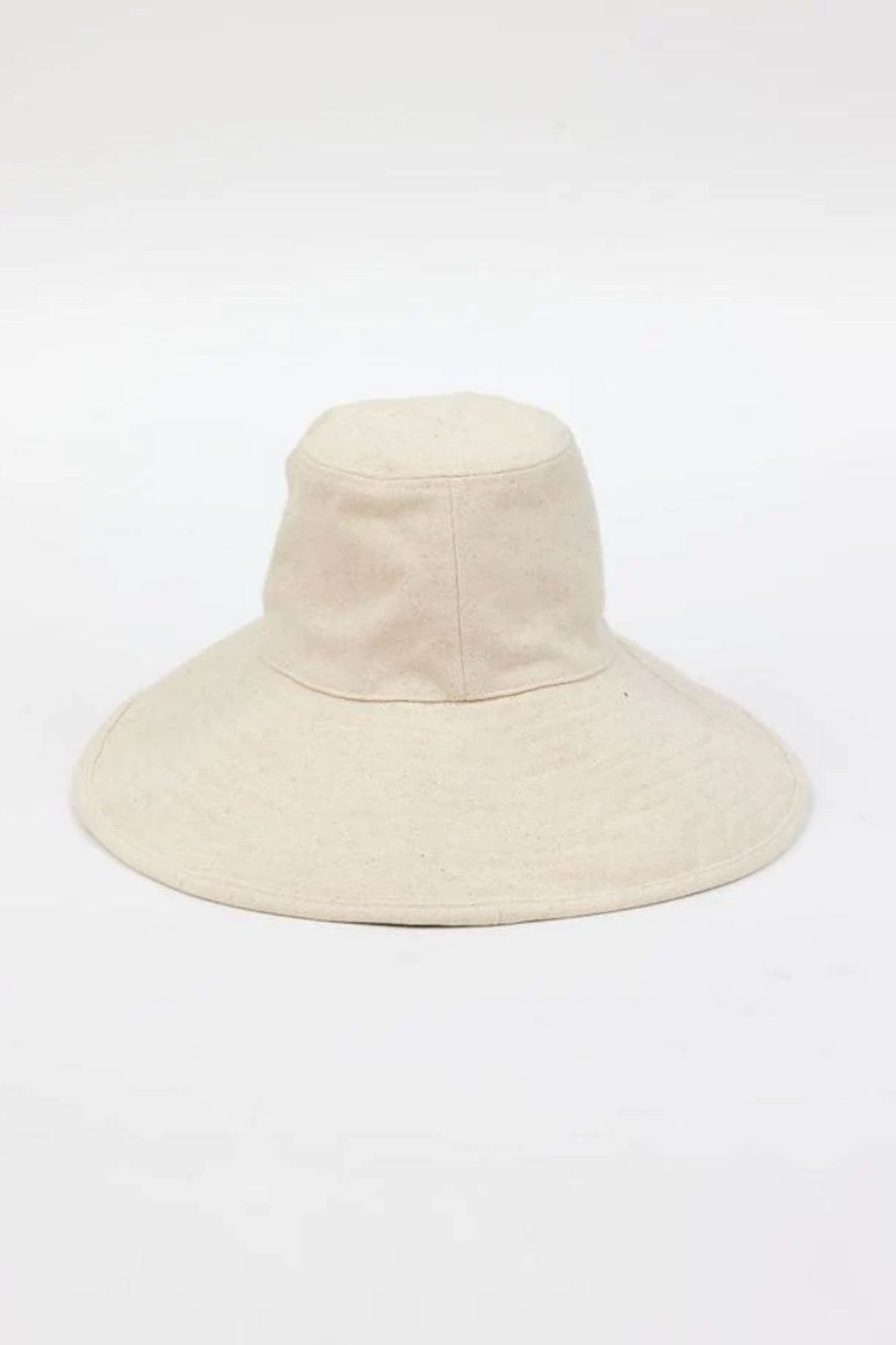 The LIVVY CANVAS SUN HAT by Velvet by Graham & Spencer is a wide-brimmed, beige fabric hat with an elevated crown, set against a simple white background.-38895645262017