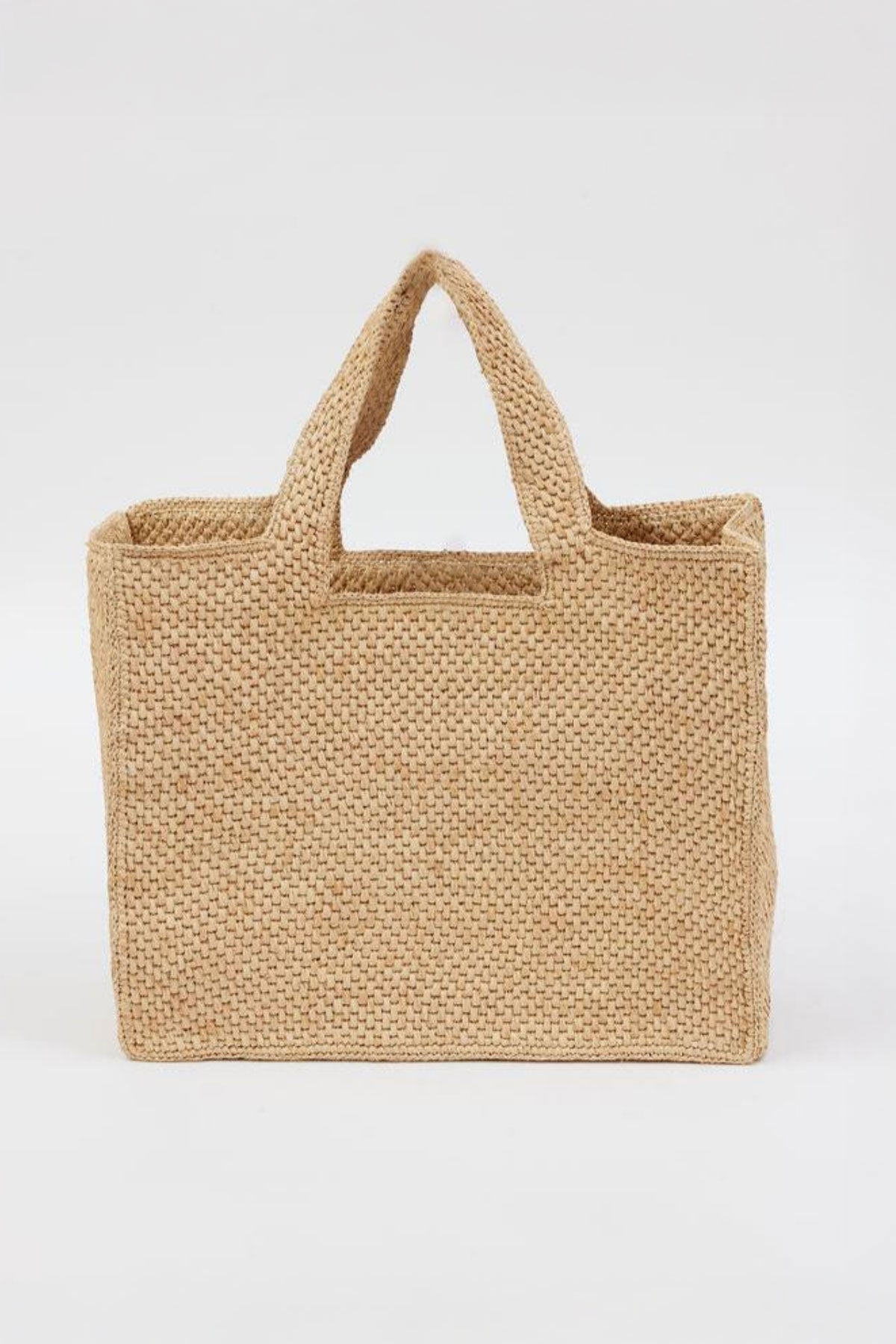 The LULU TOTE by Velvet by Graham & Spencer is a rectangular woven straw tote with two handles, displayed on a plain white background.